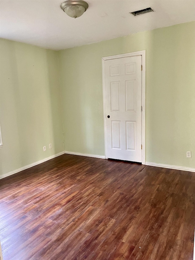 spare room with dark hardwood / wood-style floors