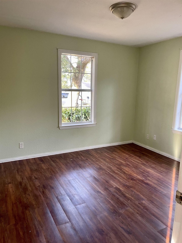 spare room featuring dark hardwood / wood-style flooring