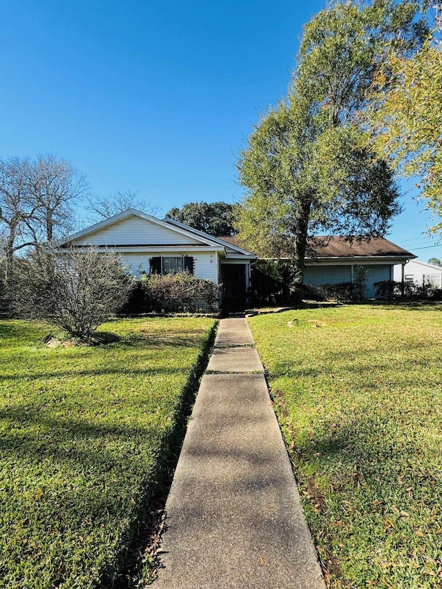 ranch-style home with a front lawn