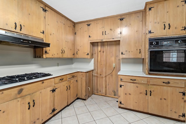 3785 Stanley Dr, Vidor, TX 77662 - kitchen featuring black appliances, under cabinet range hood, light countertops, and light tile patterned floors