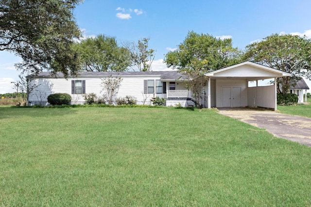 view of front of house with a front lawn and a carport