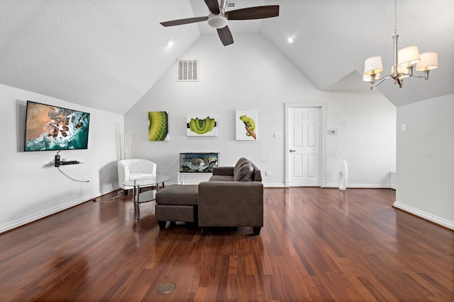 living room with lofted ceiling, ceiling fan with notable chandelier, and dark wood-type flooring