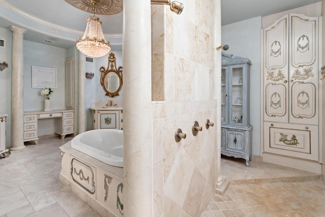 bathroom with tiled bath, ornate columns, and ornamental molding