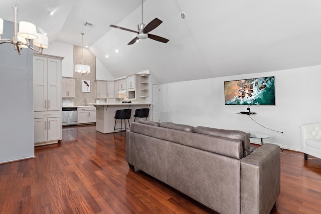 living room with ceiling fan with notable chandelier, dark hardwood / wood-style flooring, sink, and vaulted ceiling