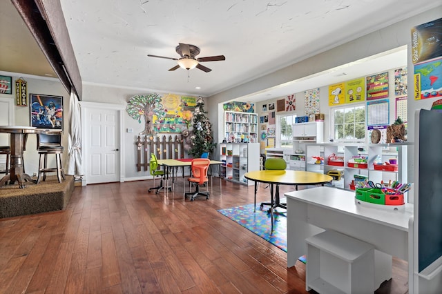 dining room with ceiling fan, crown molding, and hardwood / wood-style flooring