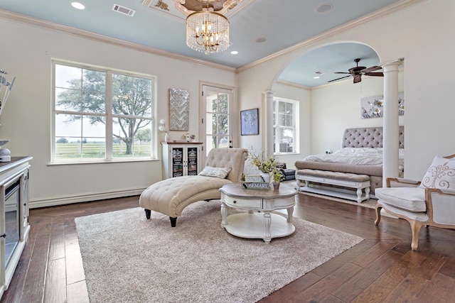 bedroom with decorative columns, dark wood-type flooring, a baseboard radiator, and an inviting chandelier