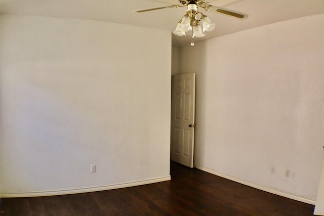 spare room with dark hardwood / wood-style flooring and ceiling fan