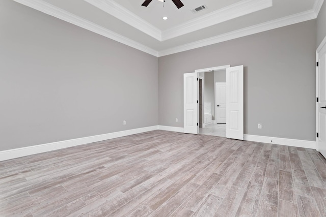 7705 Water Edge, Beaumont, TX 77707 - unfurnished bedroom featuring light wood-style flooring, a tray ceiling, ornamental molding, baseboards, and ceiling fan