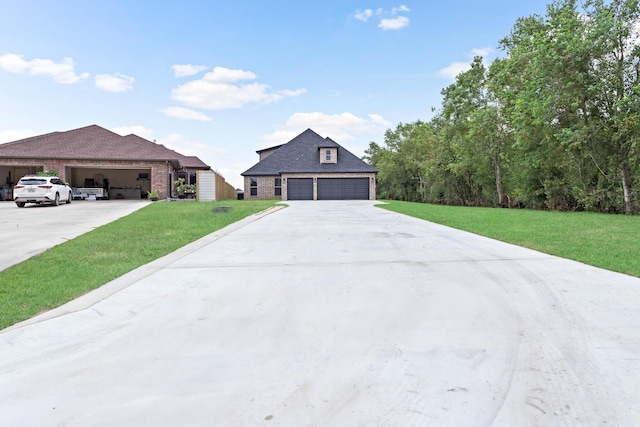 7705 Water Edge, Beaumont, TX 77707 - view of front of property with a front yard, brick siding, concrete driveway, and an outdoor structure