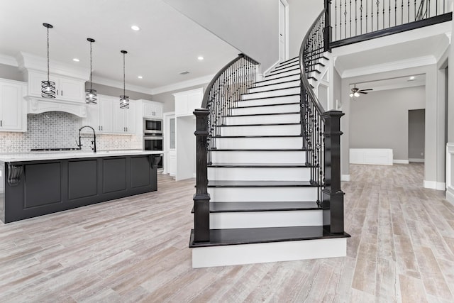 7705 Water Edge, Beaumont, TX 77707 - stairs featuring wood finished floors, recessed lighting, a ceiling fan, ornamental molding, and baseboards