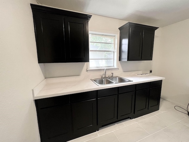 265 W Hartel St, Sour Lake, TX 77659 - kitchen with a sink, dark cabinetry, and light countertops