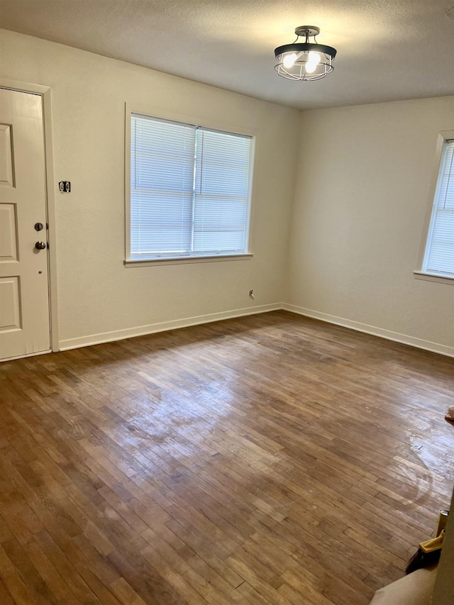 265 W Hartel St, Sour Lake, TX 77659 - spare room with dark wood finished floors, plenty of natural light, and baseboards
