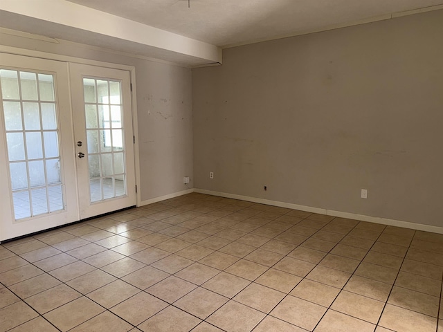 tiled spare room with french doors