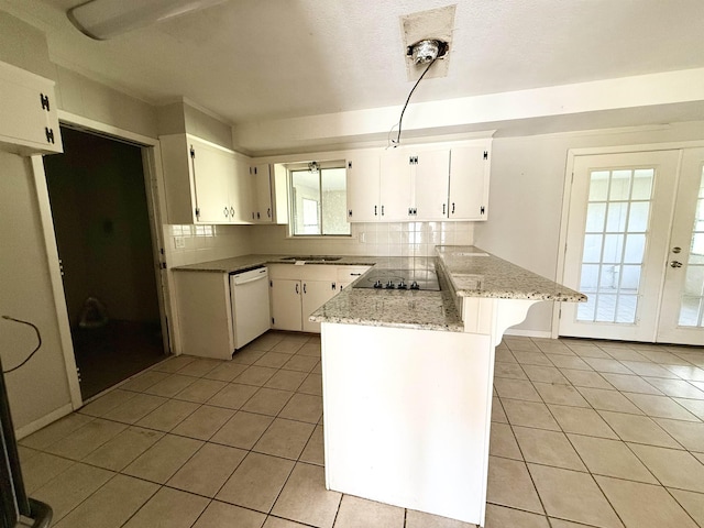 kitchen featuring white cabinets, light stone counters, kitchen peninsula, and white dishwasher