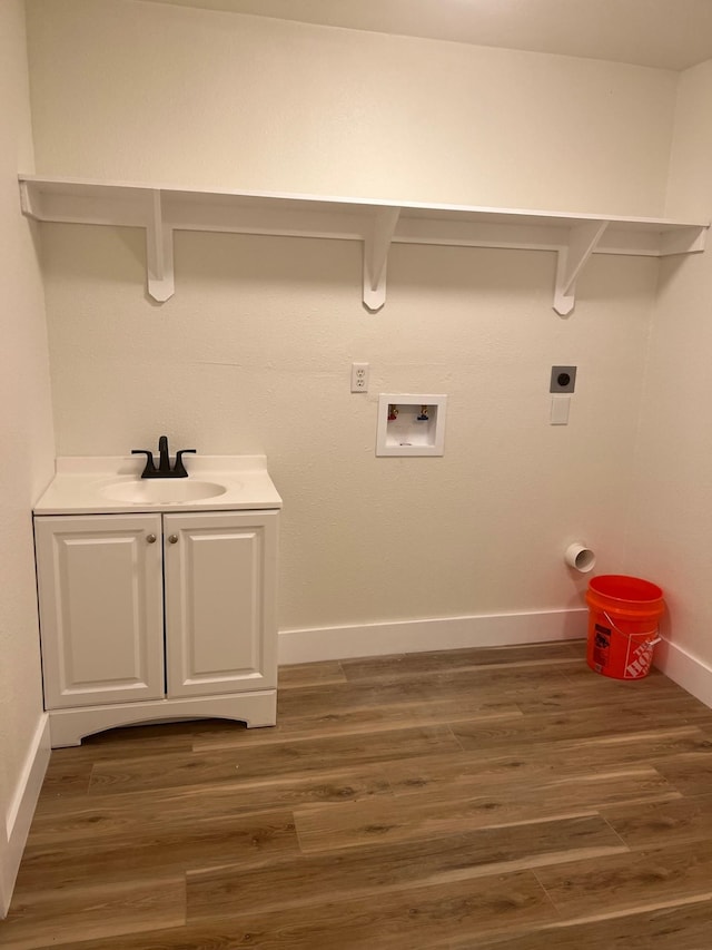 100 Country Club Dr, Beaumont, TX 77705 - washroom featuring washer hookup, hookup for an electric dryer, wood finished floors, a sink, and baseboards