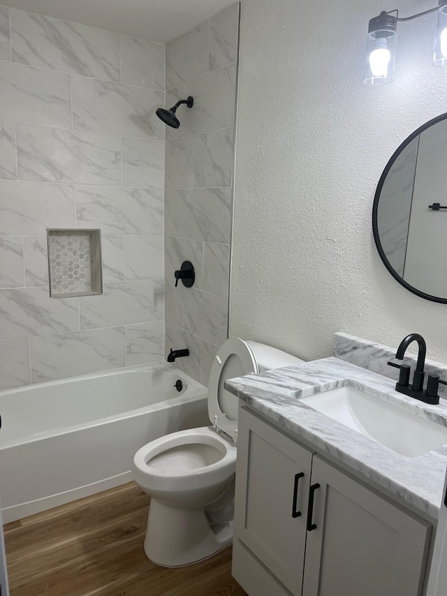 100 Country Club Dr, Beaumont, TX 77705 - full bath featuring shower / bathing tub combination, wood finished floors, vanity, toilet, and a textured wall