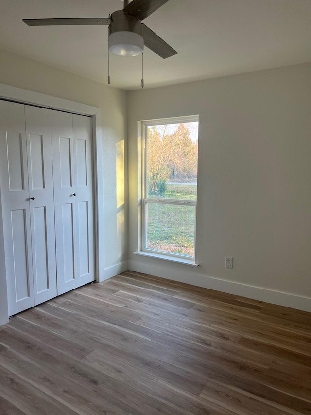 100 Country Club Dr, Beaumont, TX 77705 - unfurnished bedroom featuring a ceiling fan, baseboards, wood finished floors, and a closet