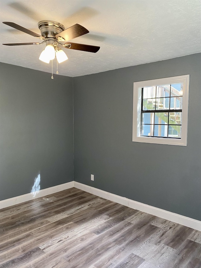 unfurnished room with wood-type flooring, a textured ceiling, and ceiling fan