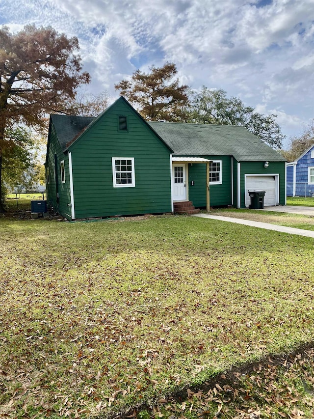 ranch-style home with central air condition unit, a front yard, and a garage