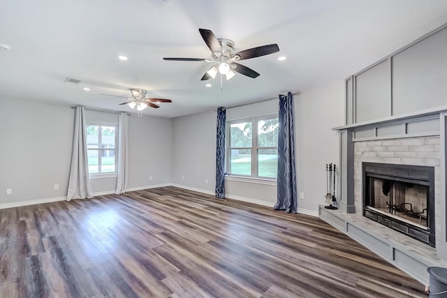 175 Triangle Dr, Vidor, TX 77662 - unfurnished living room featuring plenty of natural light, ceiling fan, wood finished floors, a fireplace with raised hearth, and recessed lighting