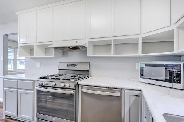 175 Triangle Dr, Vidor, TX 77662 - kitchen featuring open shelves, appliances with stainless steel finishes, white cabinetry, light stone counters, and under cabinet range hood
