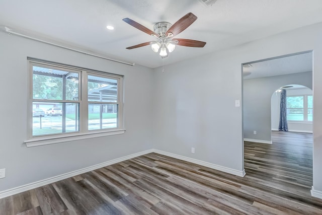 175 Triangle Dr, Vidor, TX 77662 - empty room with arched walkways, wood finished floors, a ceiling fan, baseboards, and recessed lighting