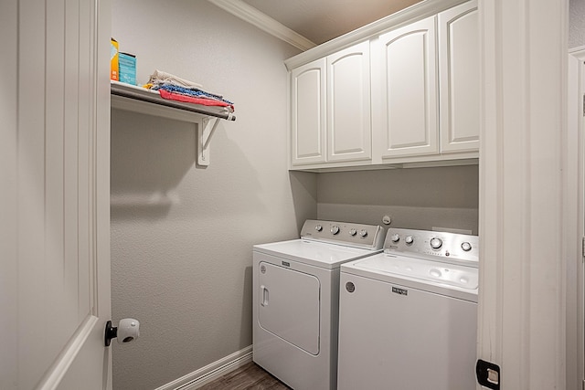 7495 Broussard Rd, Beaumont, TX 77713 - laundry area featuring washing machine and clothes dryer, cabinet space, crown molding, and dark wood-style flooring