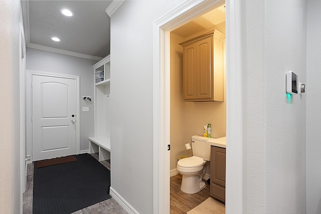 7495 Broussard Rd, Beaumont, TX 77713 - bathroom with crown molding, wood finished floors, vanity, and recessed lighting