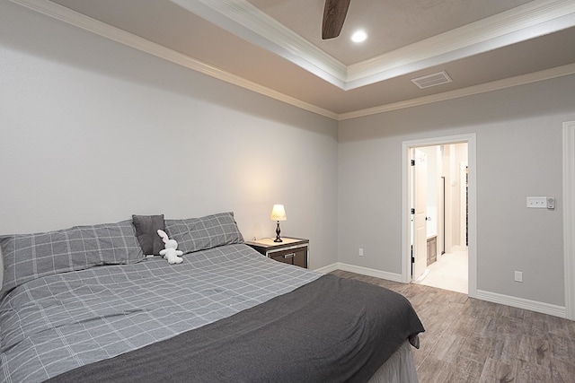 7495 Broussard Rd, Beaumont, TX 77713 - bedroom with a tray ceiling, ornamental molding, wood finished floors, recessed lighting, and ceiling fan