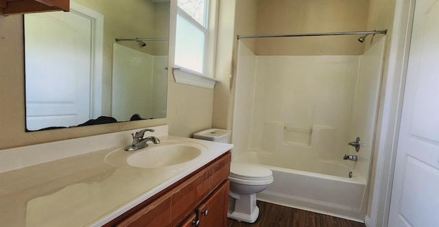 full bathroom featuring vanity, hardwood / wood-style flooring, toilet, and shower / bathtub combination