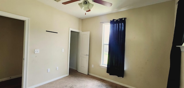 unfurnished bedroom featuring ceiling fan and light carpet