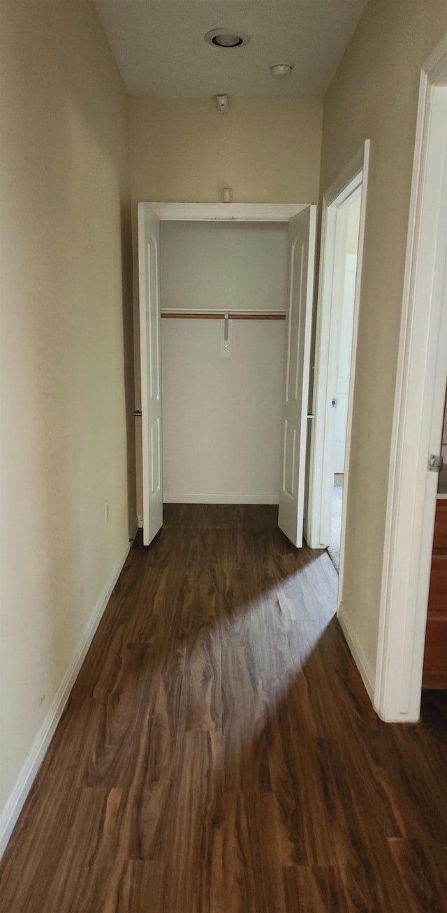 unfurnished bedroom with a closet and dark hardwood / wood-style floors