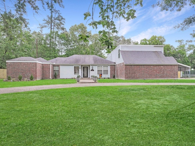 view of front of property with brick siding and a front yard
