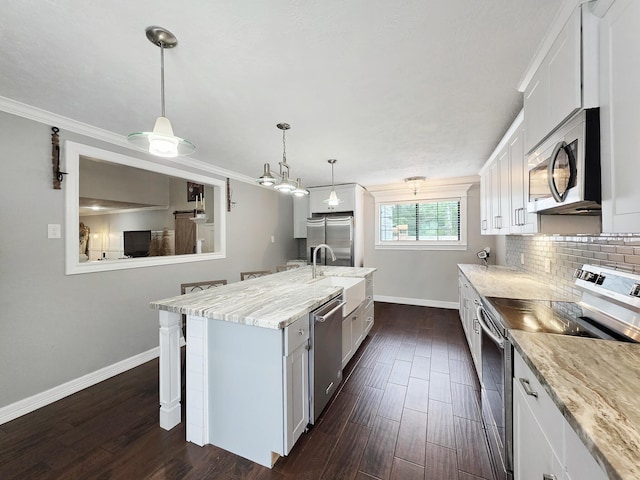 kitchen with appliances with stainless steel finishes, dark wood finished floors, white cabinetry, baseboards, and a kitchen bar