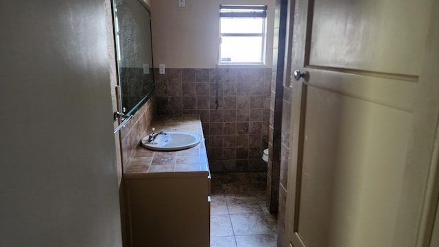 340 Maxwell Dr, Beaumont, TX 77707 - bathroom featuring tile walls, tile patterned floors, vanity, and toilet