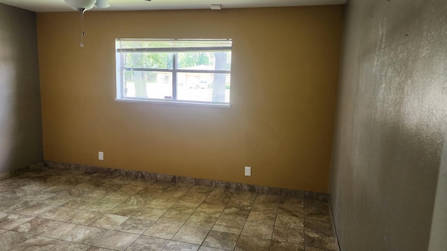 340 Maxwell Dr, Beaumont, TX 77707 - unfurnished room featuring baseboards, stone finish flooring, and a ceiling fan