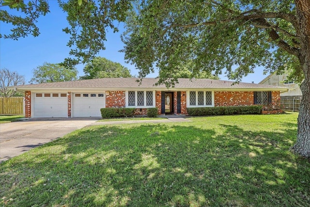 1004 Louise Dr, Nederland, TX 77627 - ranch-style house featuring a garage, fence, brick siding, a front lawn, and driveway