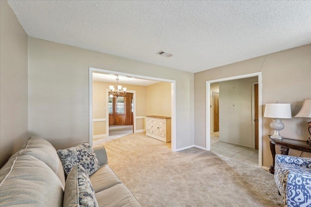 1004 Louise Dr, Nederland, TX 77627 - living room featuring visible vents, baseboards, a chandelier, a textured ceiling, and light carpet