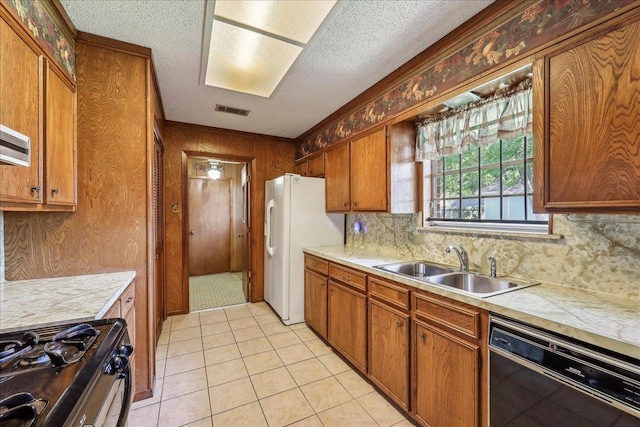1004 Louise Dr, Nederland, TX 77627 - kitchen featuring visible vents, black dishwasher, a sink, light countertops, and gas range oven