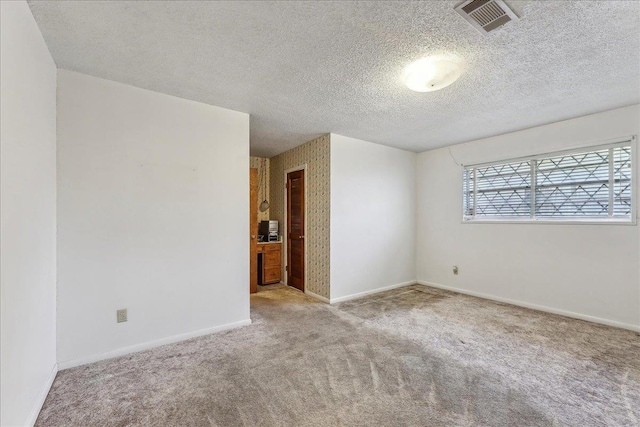 1004 Louise Dr, Nederland, TX 77627 - empty room featuring carpet, visible vents, baseboards, and a textured ceiling