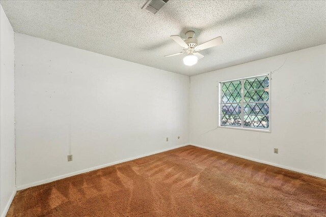 1004 Louise Dr, Nederland, TX 77627 - carpeted spare room with visible vents, baseboards, a ceiling fan, and a textured ceiling