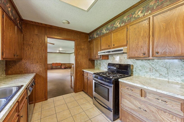 1004 Louise Dr, Nederland, TX 77627 - kitchen featuring under cabinet range hood, gas stove, light countertops, and dishwasher