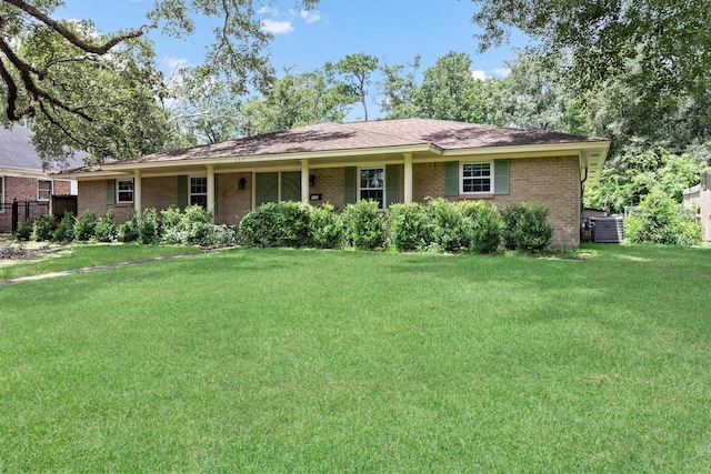 single story home with central AC and a front yard