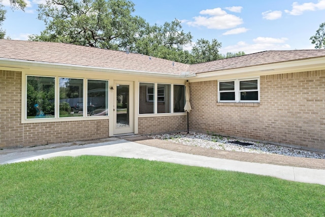 doorway to property with a yard