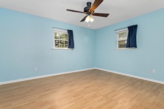 spare room featuring ceiling fan, a textured ceiling, and light wood-type flooring