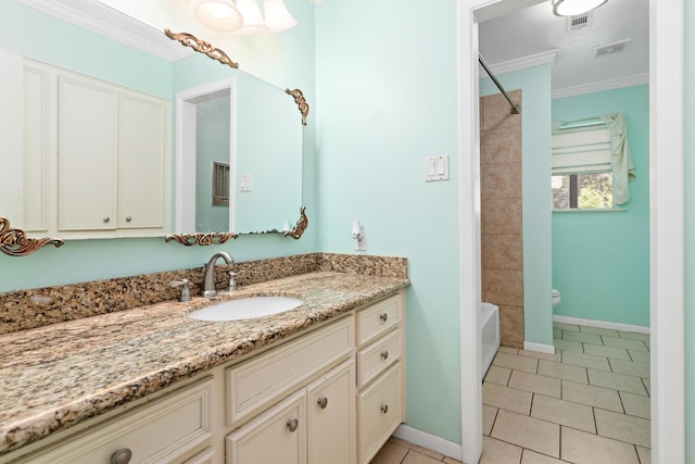 bathroom featuring tile patterned floors, vanity, crown molding, and bathing tub / shower combination