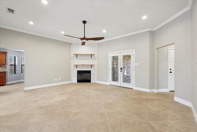 unfurnished living room with baseboards, a ceiling fan, ornamental molding, french doors, and a fireplace