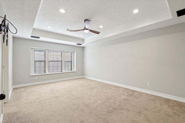 spare room featuring baseboards, a tray ceiling, a textured ceiling, carpet floors, and recessed lighting