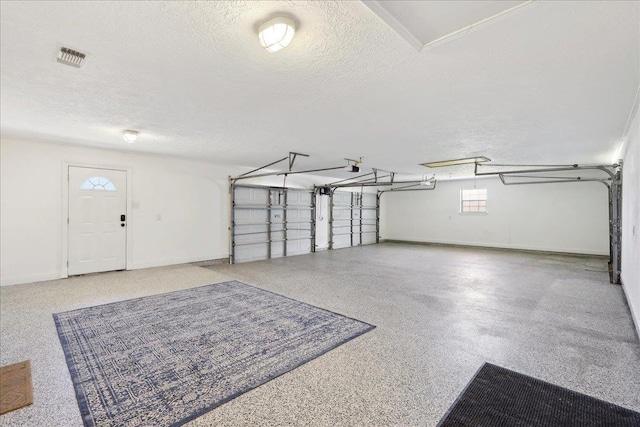 garage with visible vents and baseboards