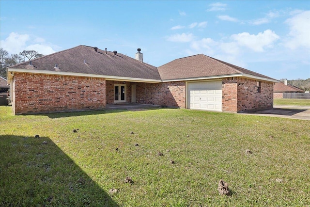 view of front of house featuring a chimney, an attached garage, french doors, a front lawn, and brick siding